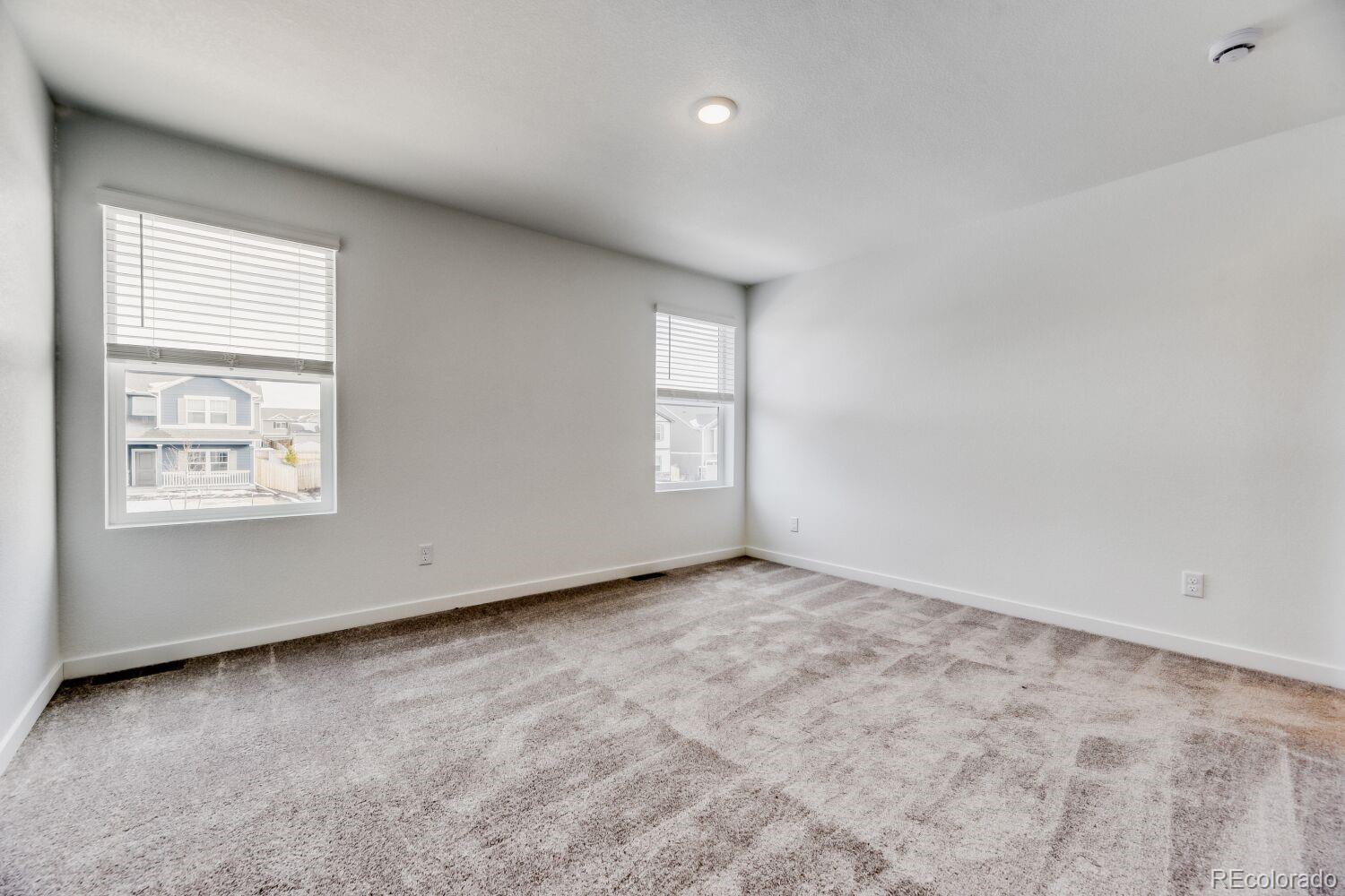 8962 Blue Feather Loop Colorado Springs, CO 80908 - Photo 9 of 18 an empty room with windows