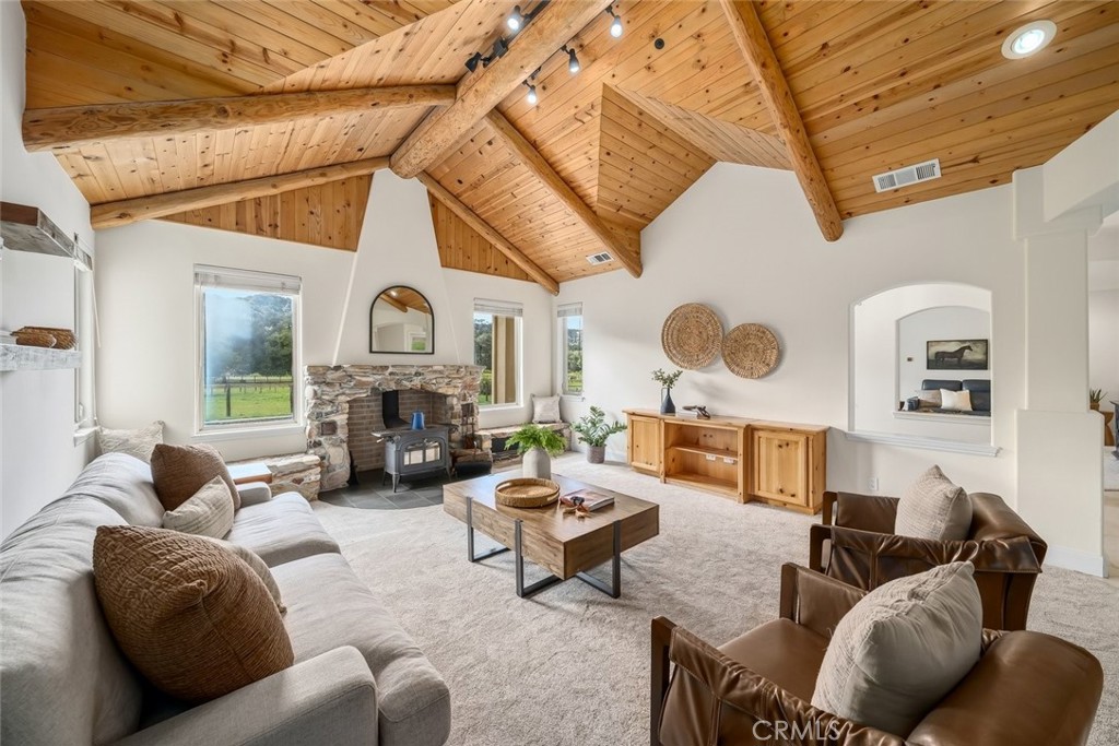 1825 Hi Mountain Road Arroyo Grande, CA 93420 - Photo 11 of 74 a living room with furniture a fireplace and a large window
