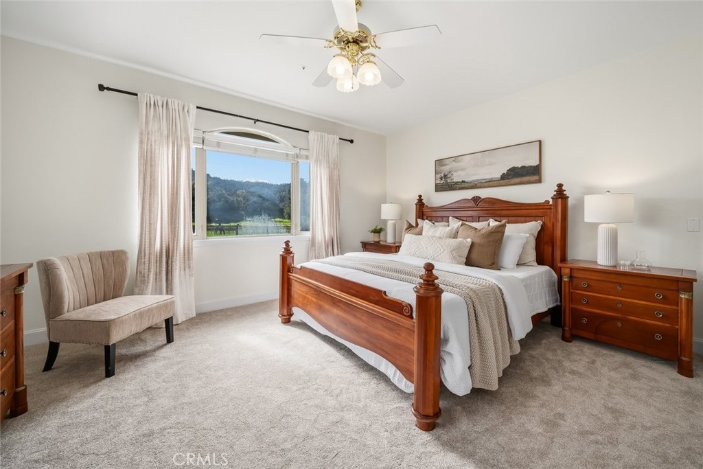 1825 Hi Mountain Road Arroyo Grande, CA 93420 - Photo 27 of 74 a bedroom with a bed a couch and a chandelier