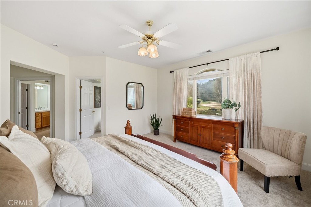 1825 Hi Mountain Road Arroyo Grande, CA 93420 - Photo 29 of 74 a bedroom with a large bed and a chandelier