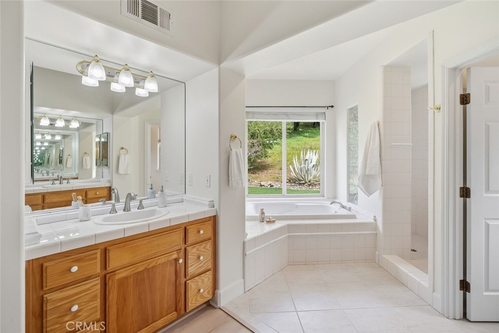 1825 Hi Mountain Road Arroyo Grande, CA 93420 - Photo 31 of 74 a spacious bathroom with a granite countertop sink mirror and a bathtub