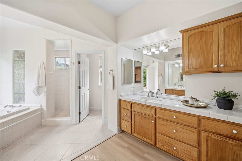 1825 Hi Mountain Road Arroyo Grande, CA 93420 - Photo 32 of 74 a spacious bathroom with a granite countertop sink mirror and shower