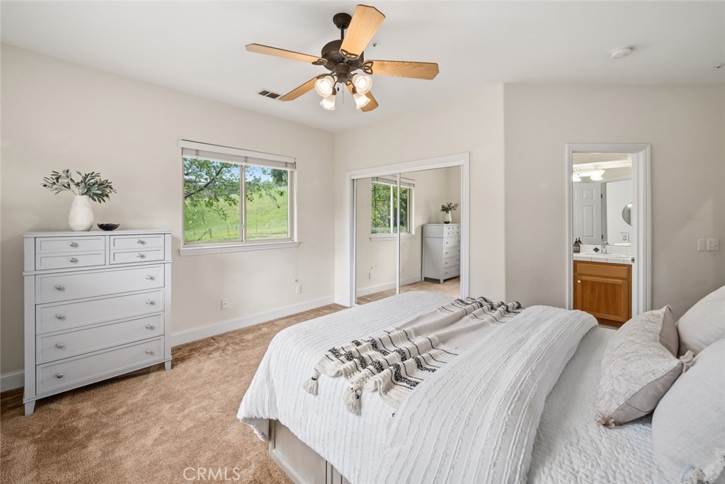 1825 Hi Mountain Road Arroyo Grande, CA 93420 - Photo 37 of 74 a bedroom with a bed a chandelier and a dresser