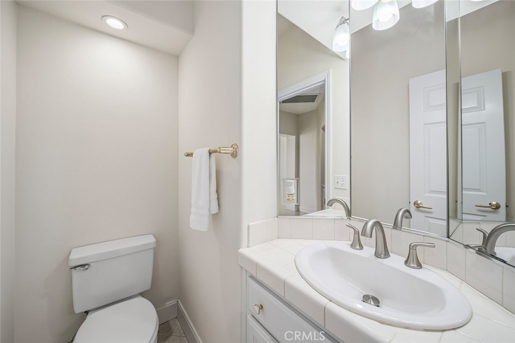 1825 Hi Mountain Road Arroyo Grande, CA 93420 - Photo 39 of 74 a bathroom with a toilet sink and mirror