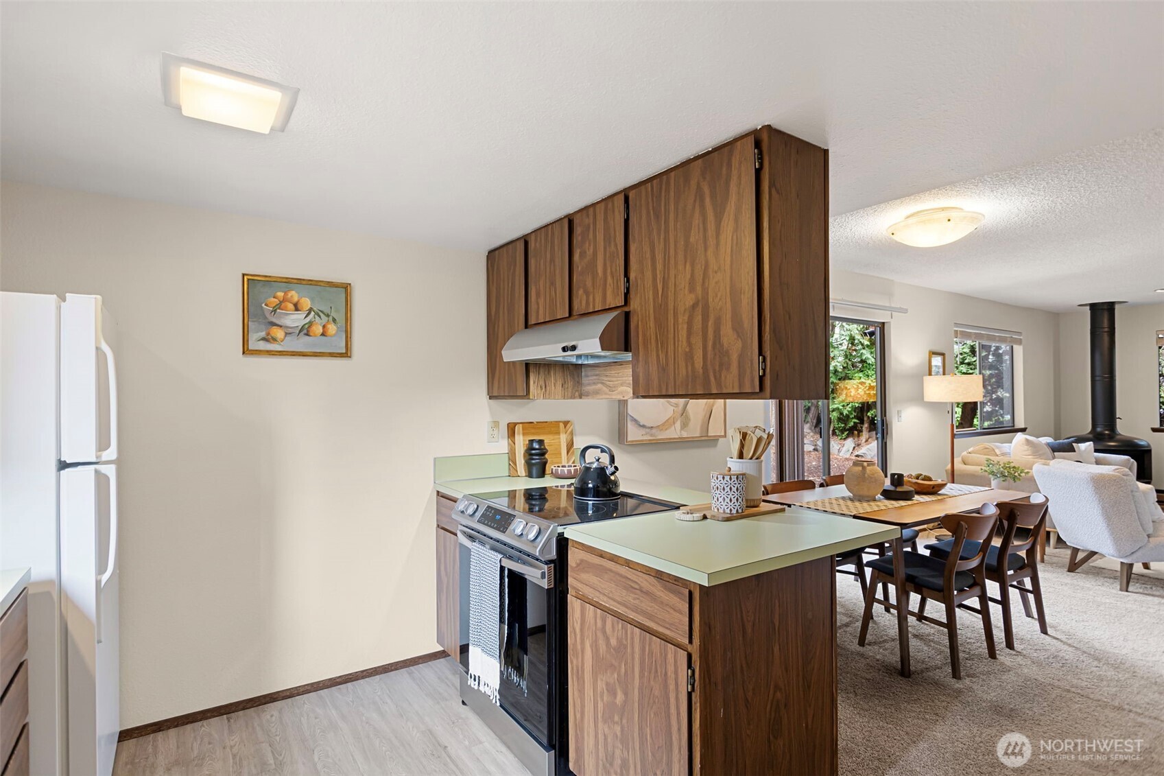 9545 Interlake Avenue North Seattle, WA 98103 - Photo 12 of 32 a kitchen with a cabinets and chairs