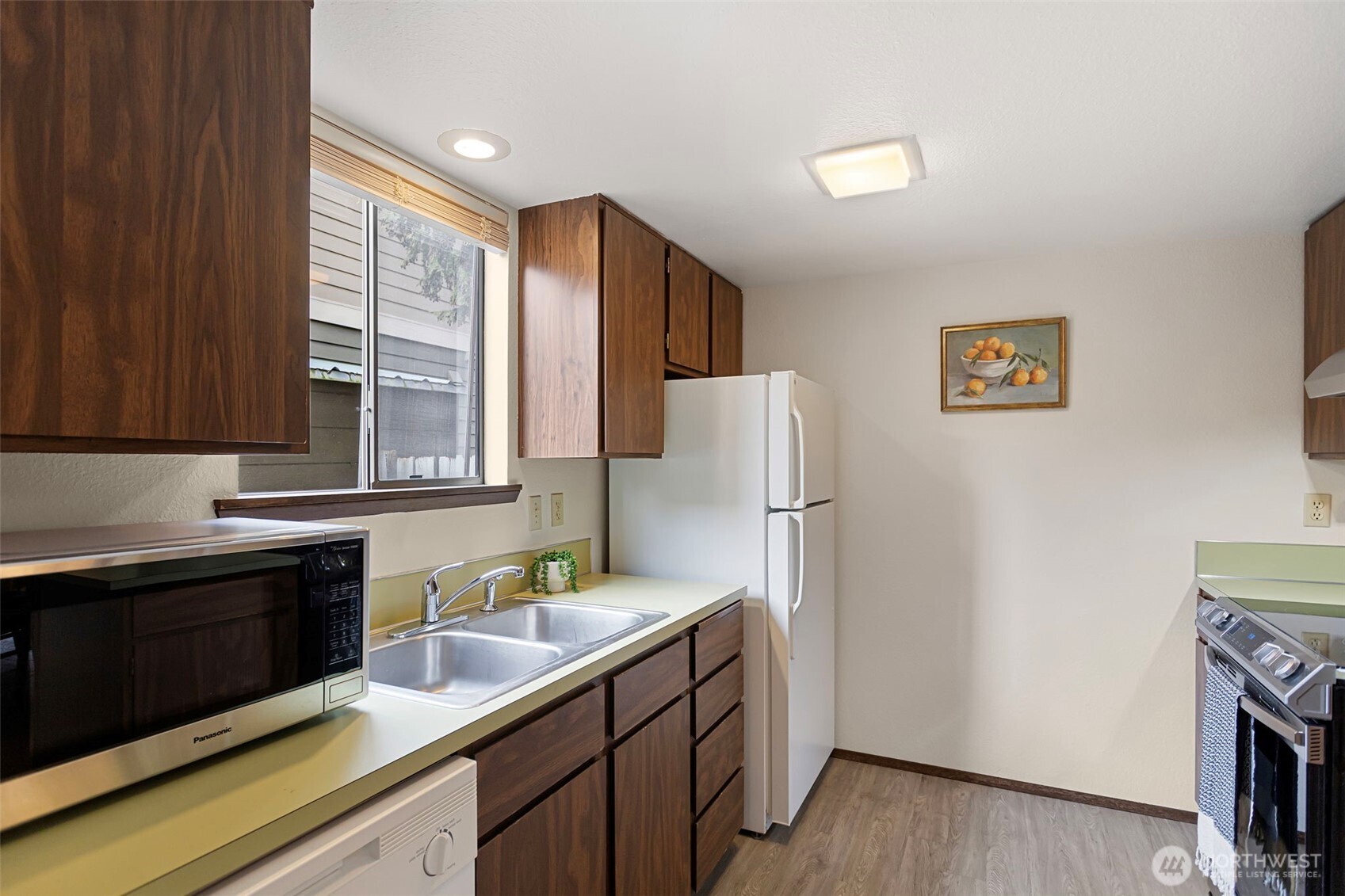 9545 Interlake Avenue North Seattle, WA 98103 - Photo 15 of 32 a kitchen with a refrigerator and a sink