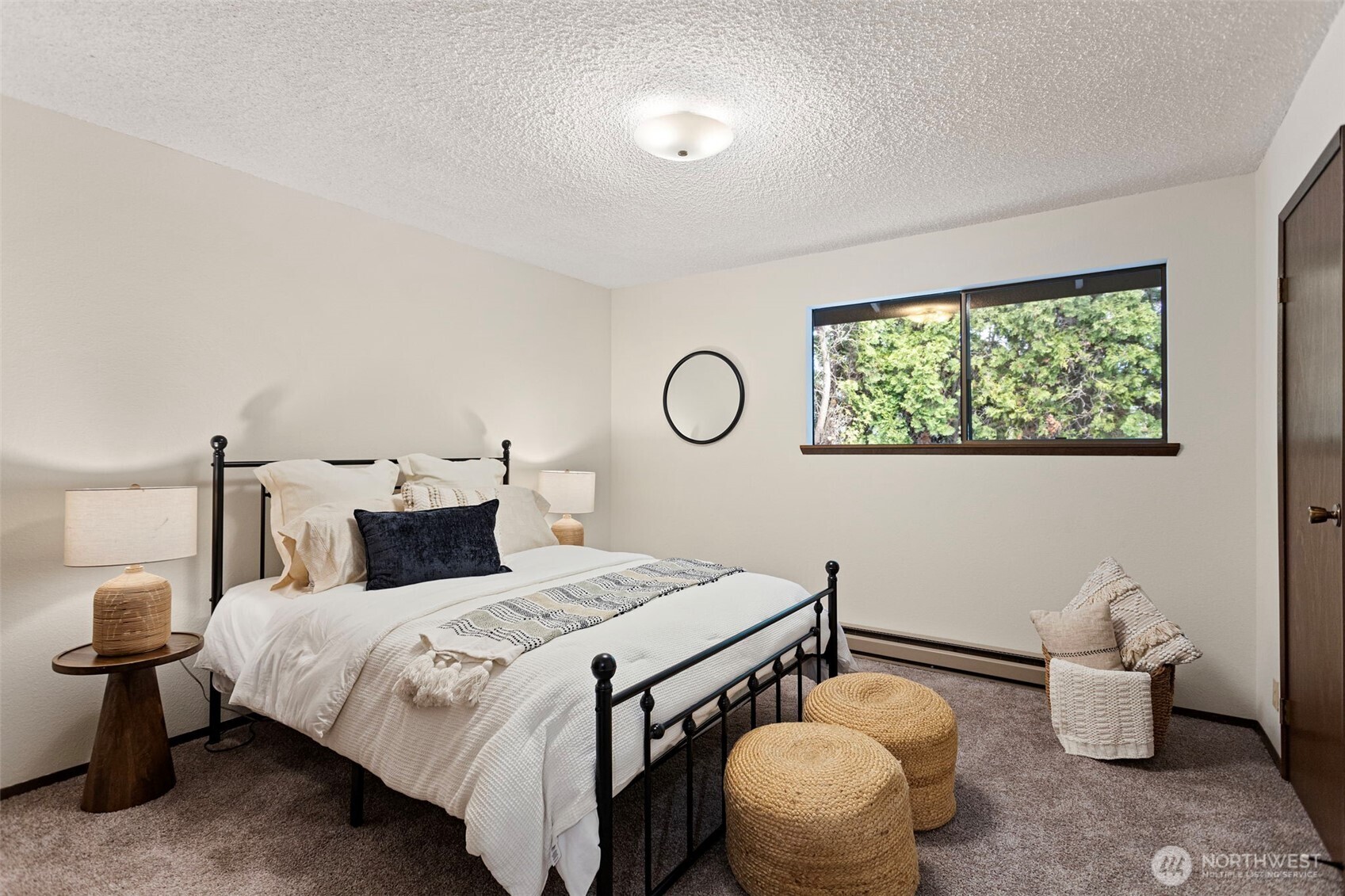 9545 Interlake Avenue North Seattle, WA 98103 - Photo 19 of 32 a bedroom with a bed and a table with lamp