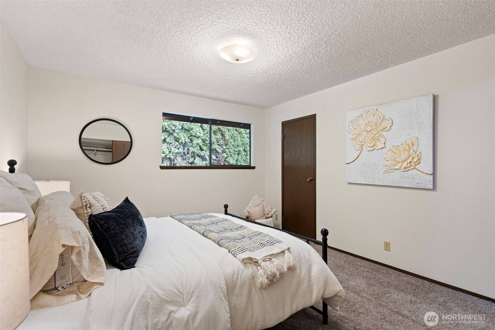 9545 Interlake Avenue North Seattle, WA 98103 - Photo 21 of 32 a bedroom with a bed and a painting on the wall