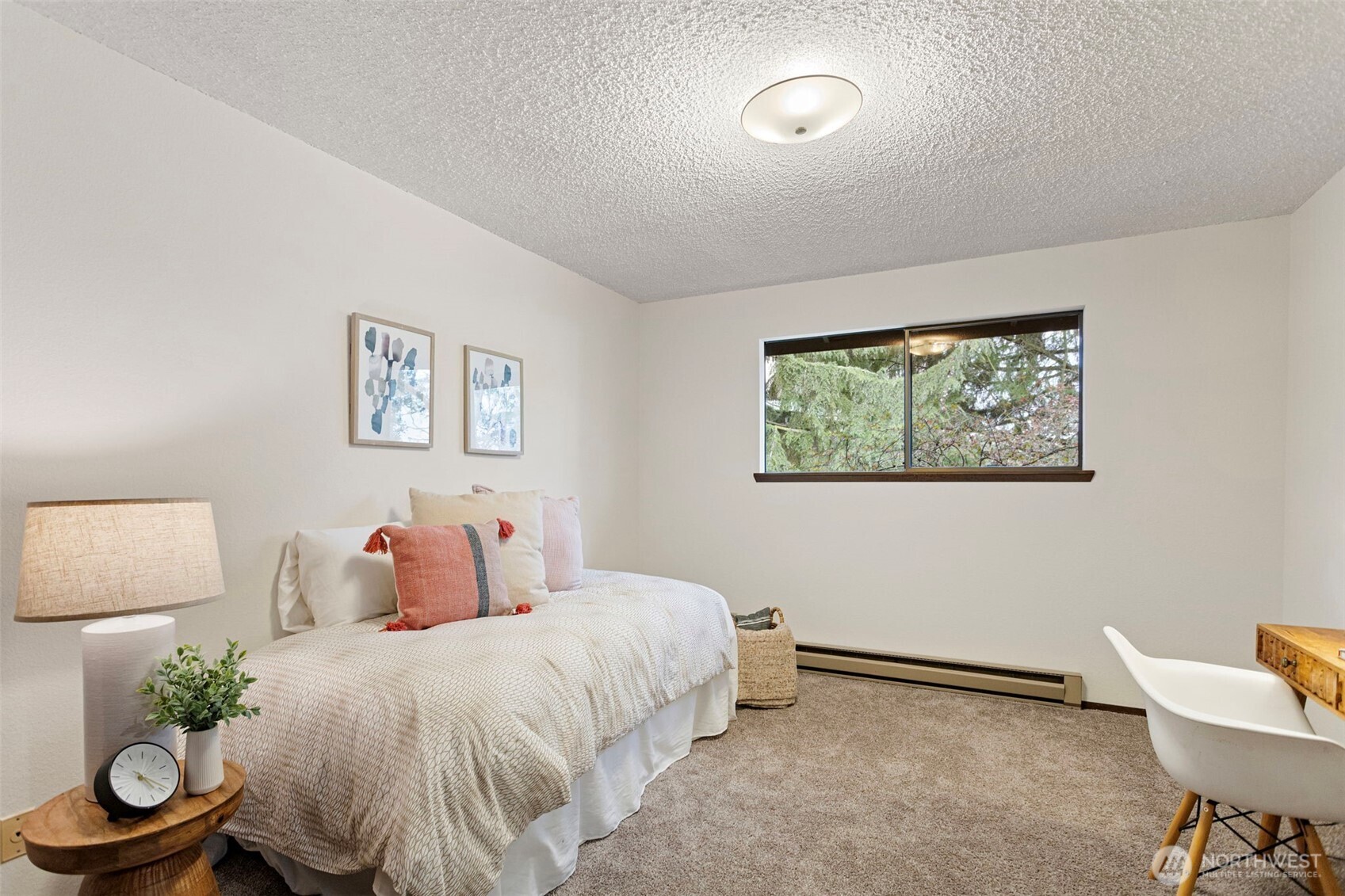 9545 Interlake Avenue North Seattle, WA 98103 - Photo 23 of 32 a bedroom with a bed and a chair