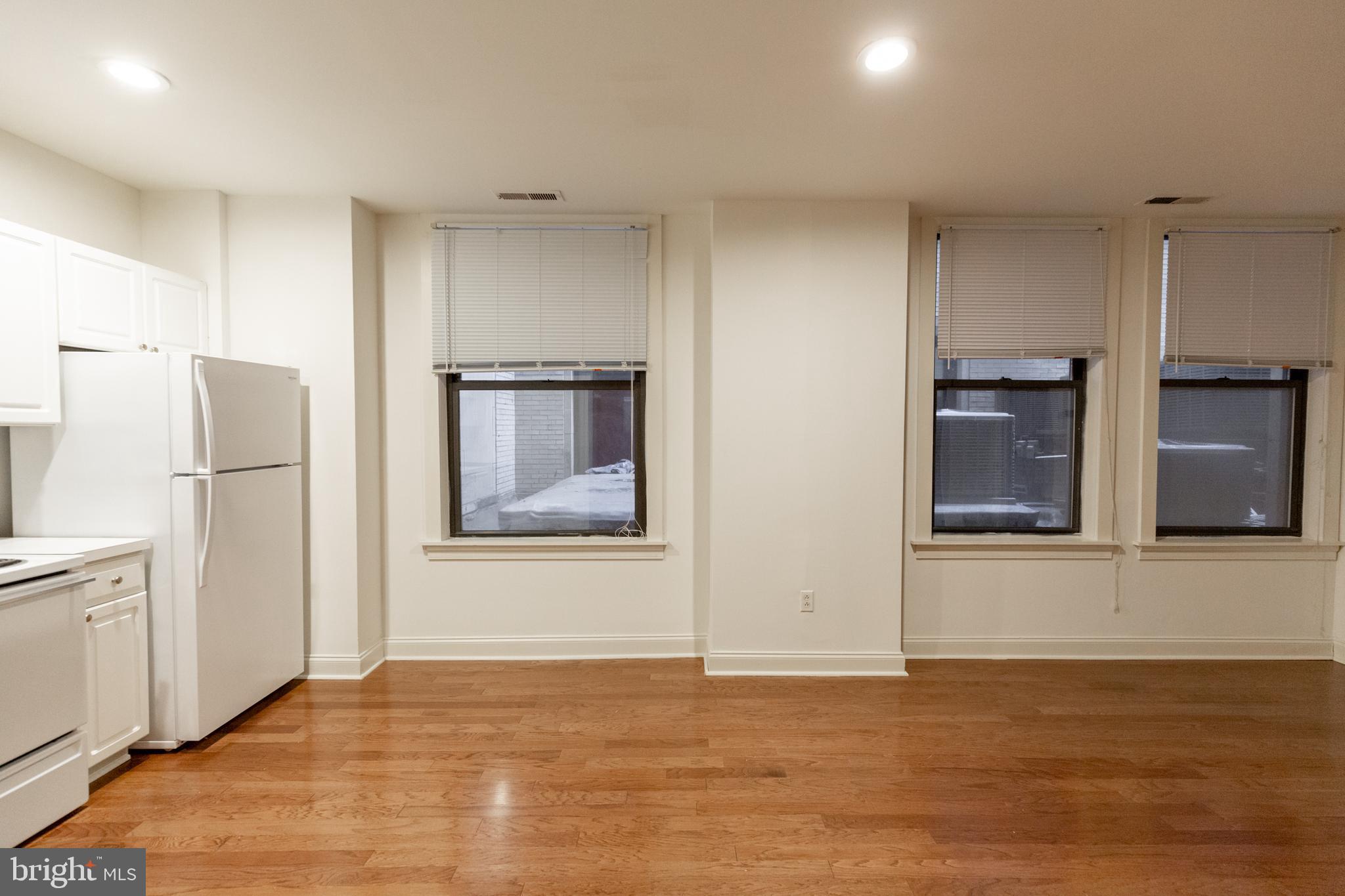 1411-4 Walnut Street, Unit 706 Philadelphia, PA 19102 - Photo 5 of 20 a view of an empty room with a kitchen and a window