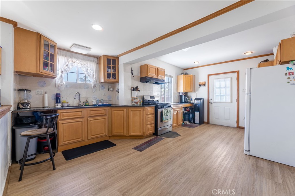 11203 Sheldon Street Sun Valley, CA 91352 - Photo 21 of 57 a kitchen with wooden floors and refrigerator