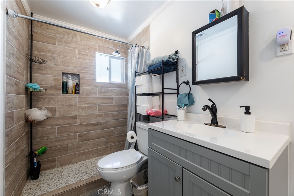 11203 Sheldon Street Sun Valley, CA 91352 - Photo 24 of 57 a bathroom with a sink toilet and mirror