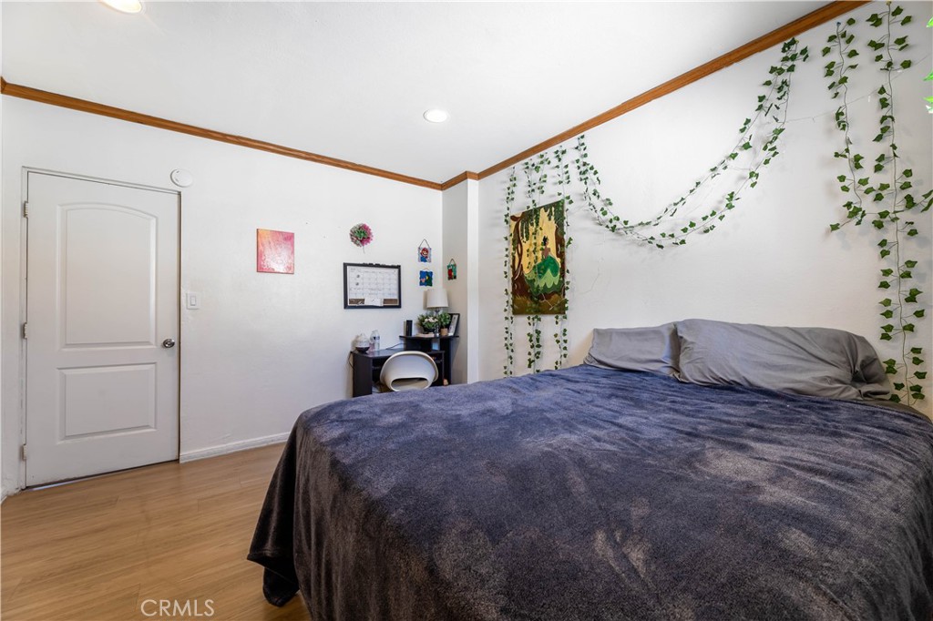 11203 Sheldon Street Sun Valley, CA 91352 - Photo 30 of 57 a bedroom with a large bed and a chandelier