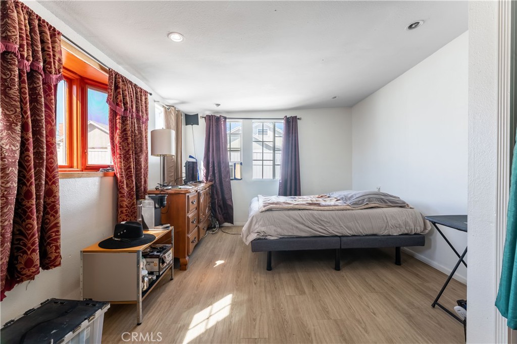 11203 Sheldon Street Sun Valley, CA 91352 - Photo 33 of 57 a bedroom with a bed and wooden floor