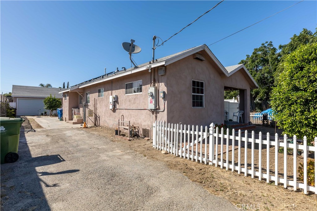 11203 Sheldon Street Sun Valley, CA 91352 - Photo 6 of 57 a view of a house with a small yard and wooden fence