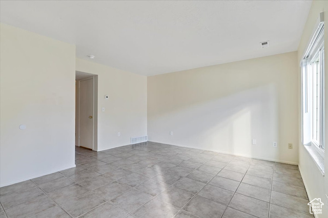 947 Canyon Road South, Unit 15 Ogden, UT 84404 - Photo 4 of 22 Empty room featuring plenty of natural light and light tile patterned floors