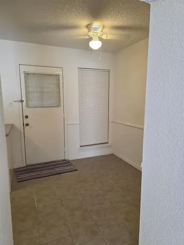 an empty room with closet and a ceiling fan