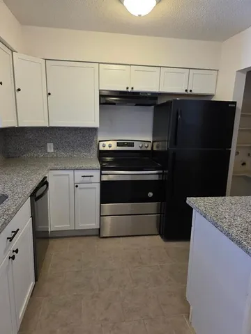 a kitchen with a stove and a refrigerator