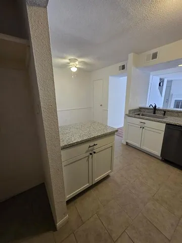a view of a kitchen counter space and appliances