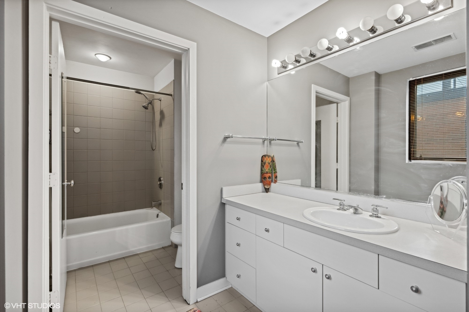 222 South Racine Avenue, Unit 607 Chicago, IL 60607 - Photo 11 of 22 a bathroom with a sink double vanity granite tub and shower