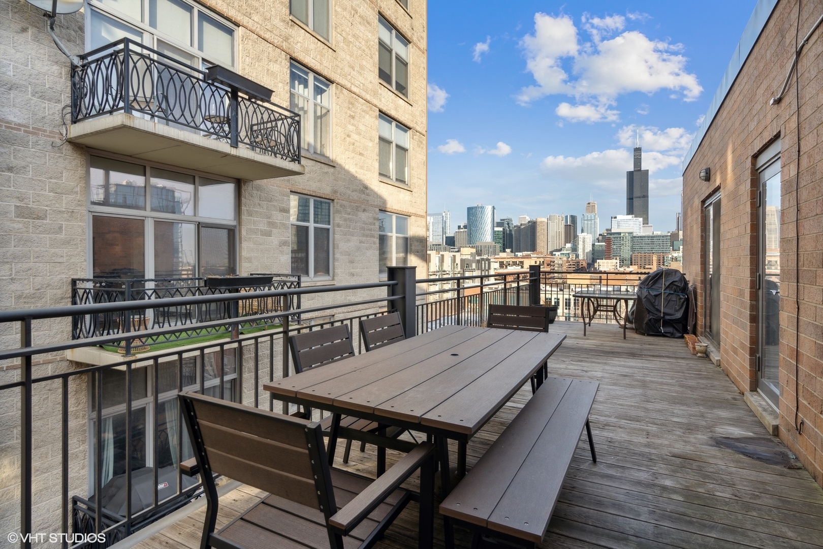 222 South Racine Avenue, Unit 607 Chicago, IL 60607 - Photo 16 of 22 a view of a roof deck with table and chairs