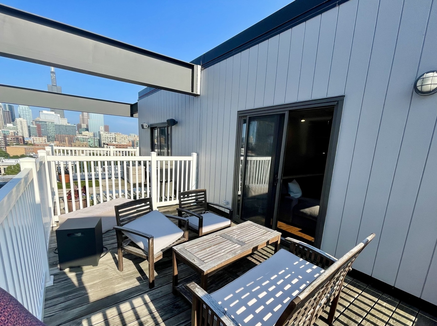 222 South Racine Avenue, Unit 607 Chicago, IL 60607 - Photo 19 of 22 a balcony with furniture and wooden floor