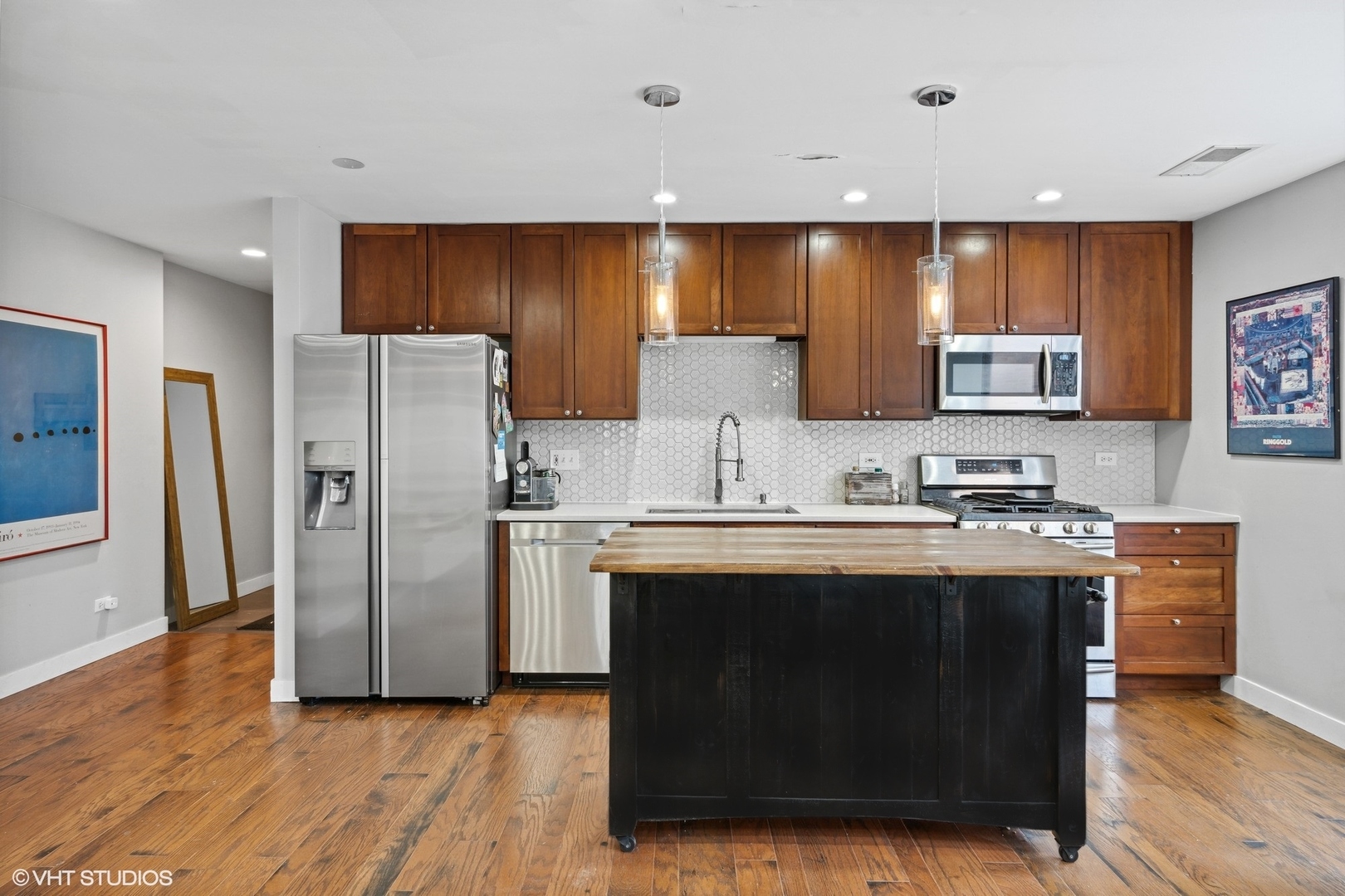 222 South Racine Avenue, Unit 607 Chicago, IL 60607 - Photo 6 of 22 a kitchen with stainless steel appliances a stove a sink a refrigerator and cabinets