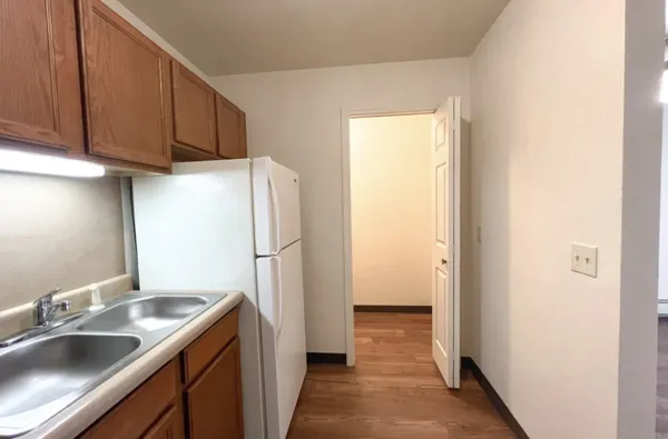a kitchen with a sink and a refrigerator