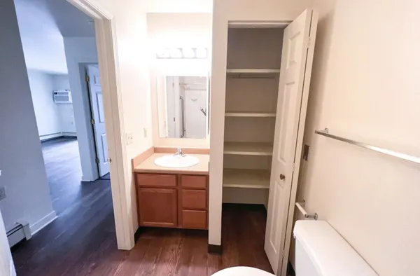 a room with a chair and a dresser