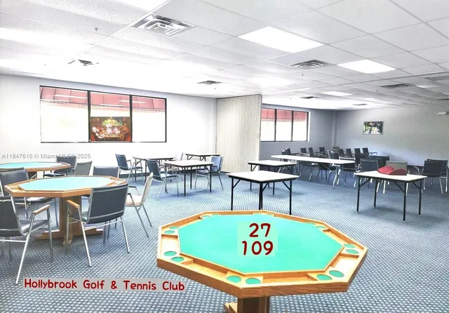 a living room with furniture a rug and a table