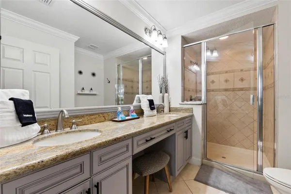 a bathroom with a granite countertop sink mirror and double