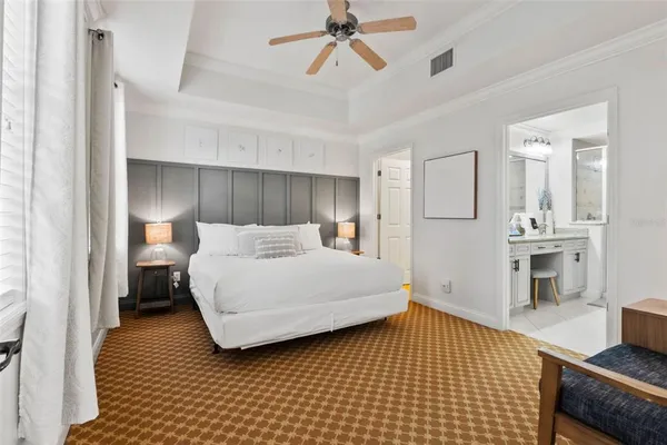 a bedroom with a bed and a view of walk in closet