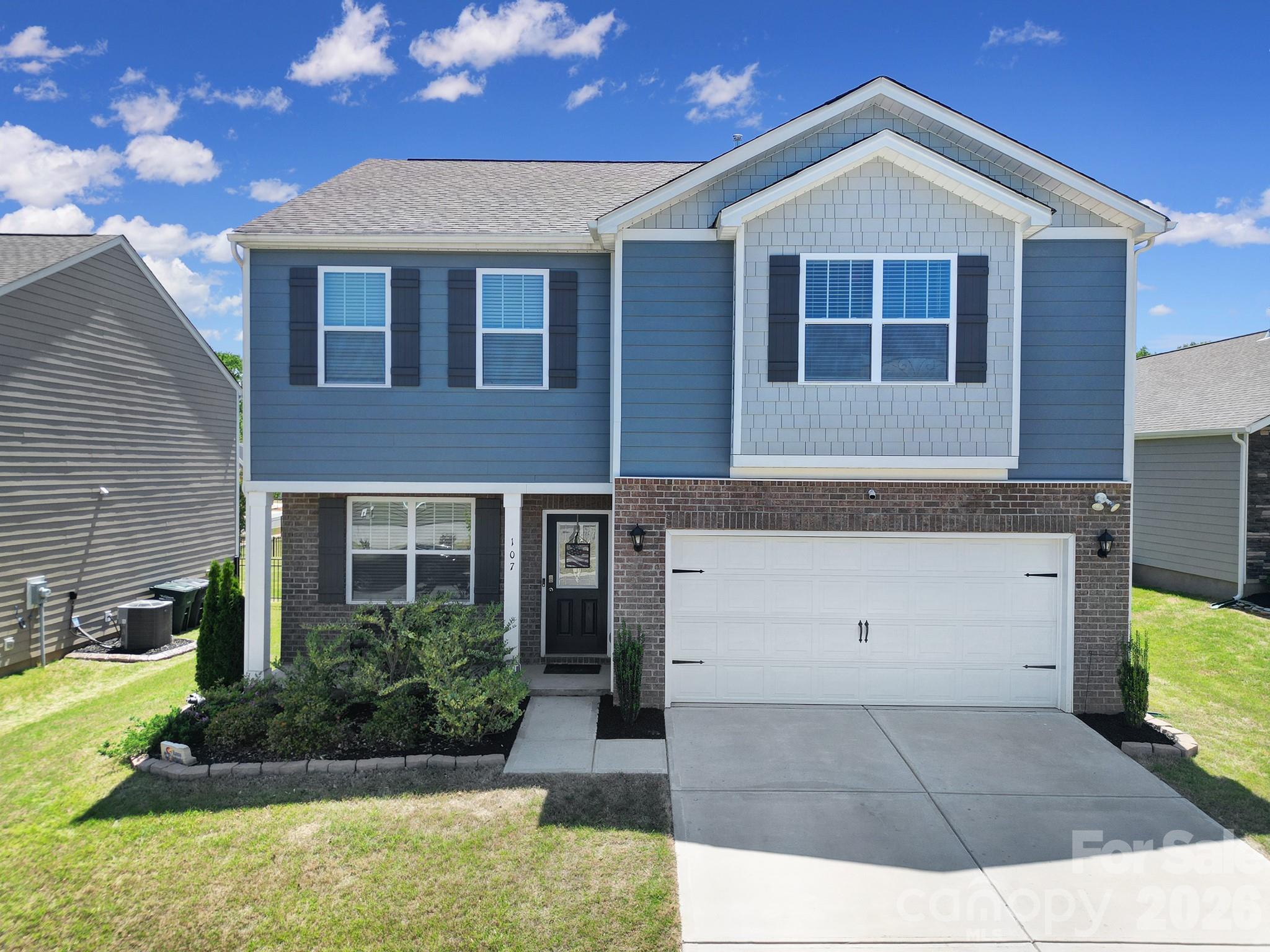 107 Spring Hall Court Troutman, NC 28166 - Photo 1 of 28 a front view of a house with garden