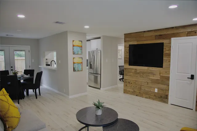 a living room with furniture and a dining table