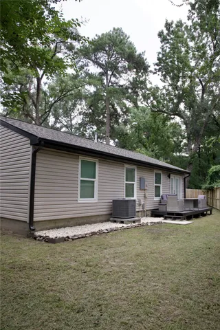a backyard of a house with yard and outdoor seating