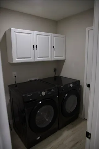 a utility room with sink and cabinets