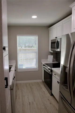a kitchen with a stove a sink and a refrigerator