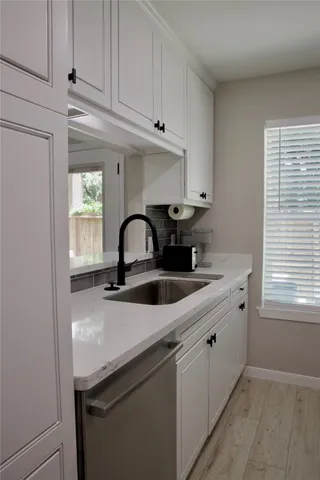 a kitchen with stainless steel appliances granite countertop a sink a stove and cabinets