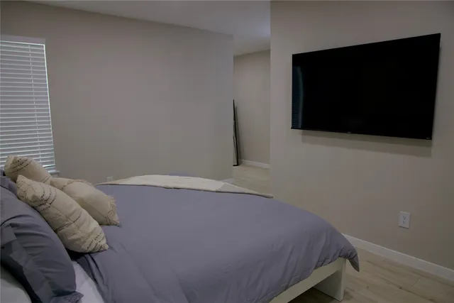 a bedroom with a bed and a flat screen tv