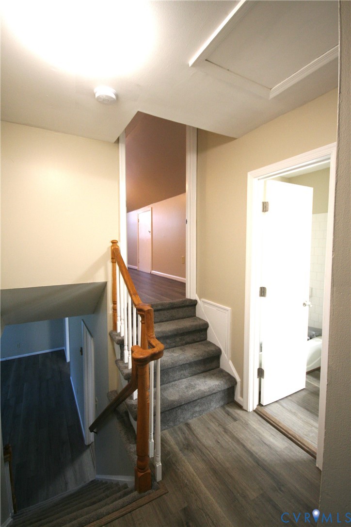 12141 Old Buckingham Road Midlothian, VA 23113 - Photo 22 of 39 Staircase featuring wood handrails and carpeted tr