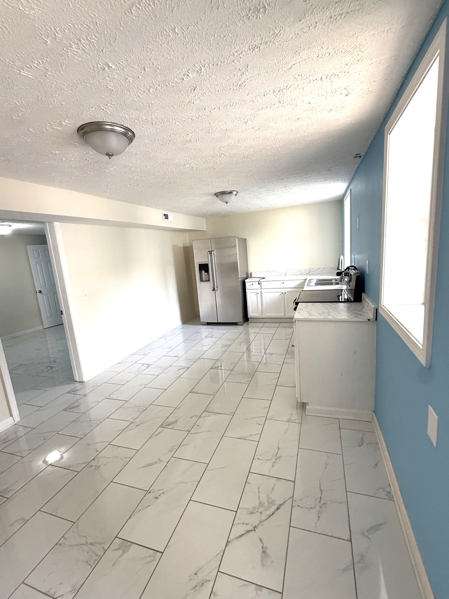 3308 Shakertown Road Antioch, TN 37013 - Photo 19 of 28 a large white kitchen with a stove a sink dishwasher and a refrigerator with wooden floor