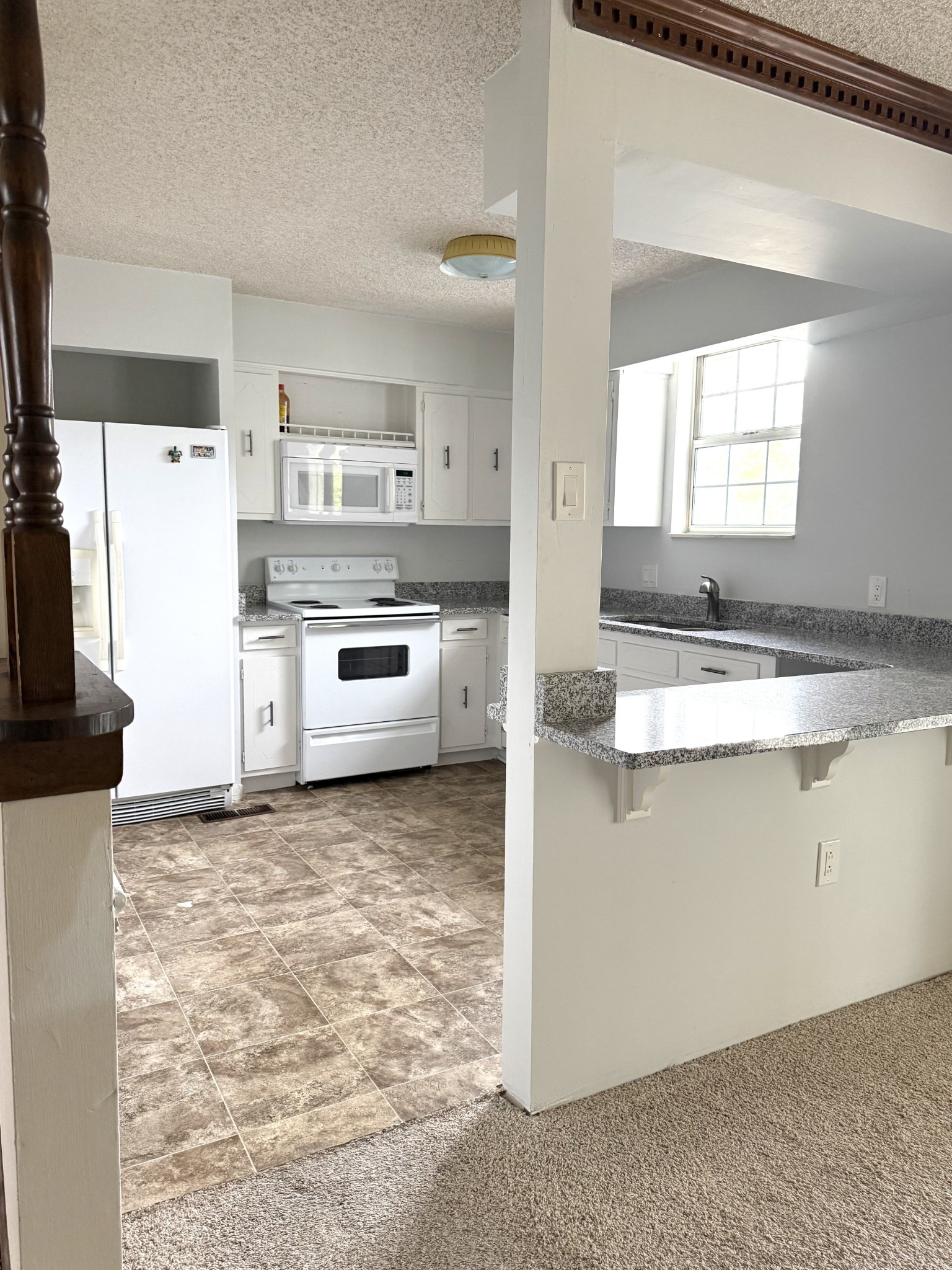 3308 Shakertown Road Antioch, TN 37013 - Photo 3 of 28 a kitchen with stainless steel appliances granite countertop a stove a sink and a refrigerator