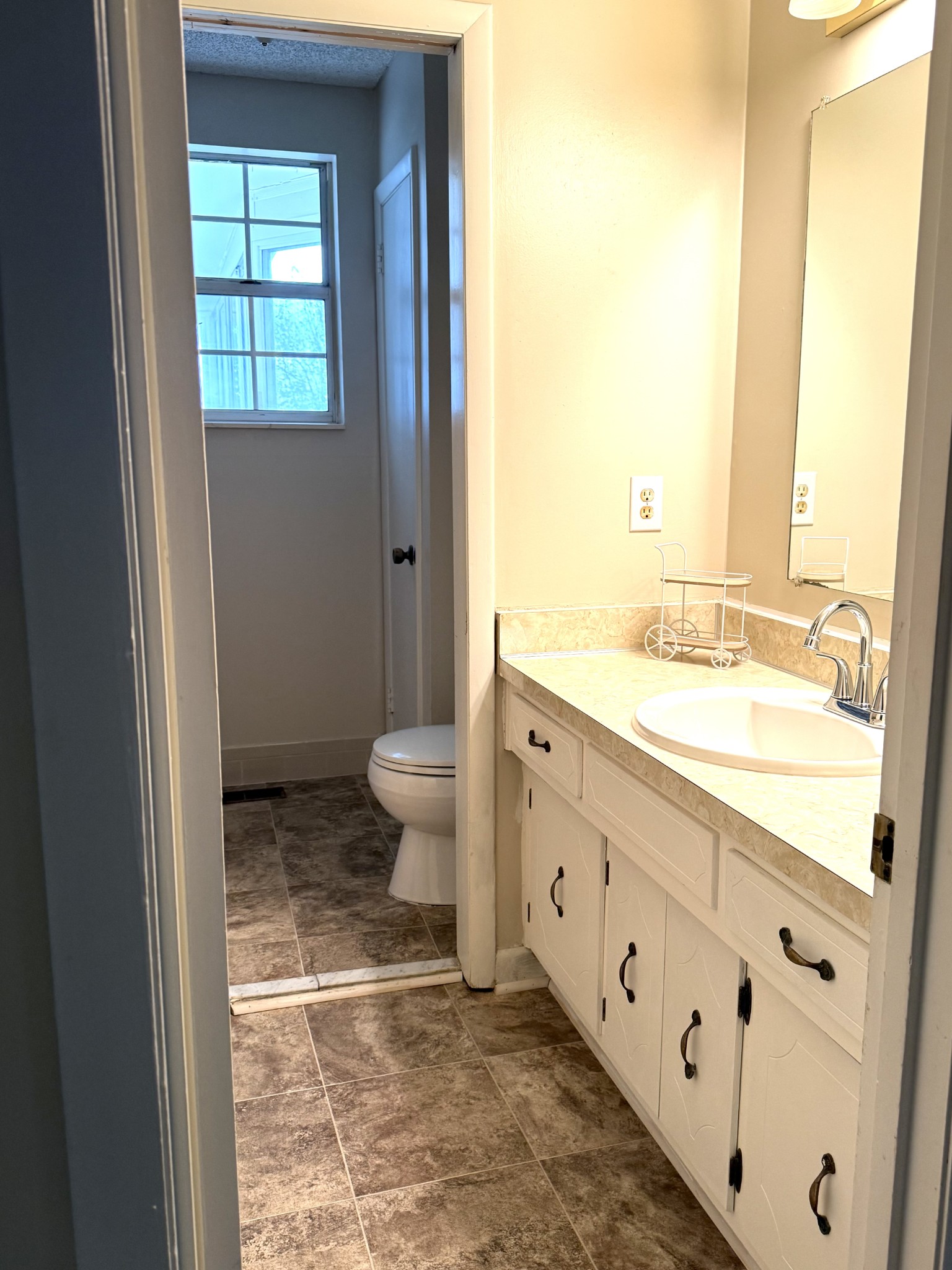 3308 Shakertown Road Antioch, TN 37013 - Photo 7 of 28 a spacious bathroom with a granite countertop sink toilet and mirror