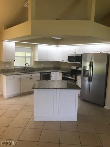 a kitchen with stainless steel appliances granite countertop a sink and cabinets