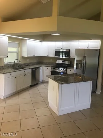 a kitchen with stainless steel appliances granite countertop a sink counter space cabinets and granite counter tops