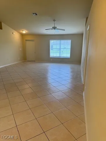 a view of an empty room and a window