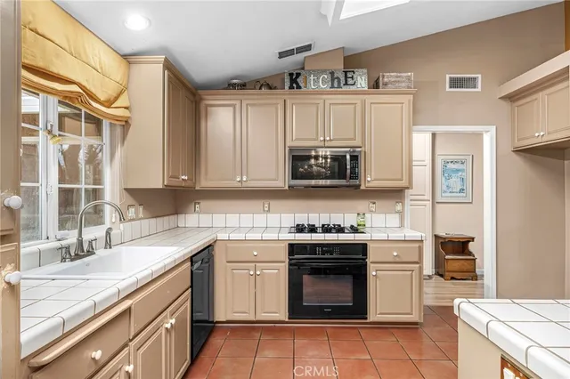 a kitchen with a stove top oven and sink