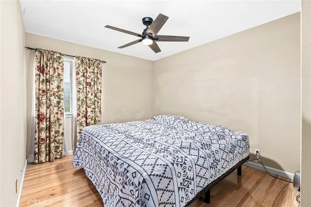 a bed sitting in a bedroom next to a window