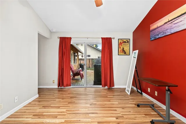 a view of a room with wooden floor and a ceiling fan