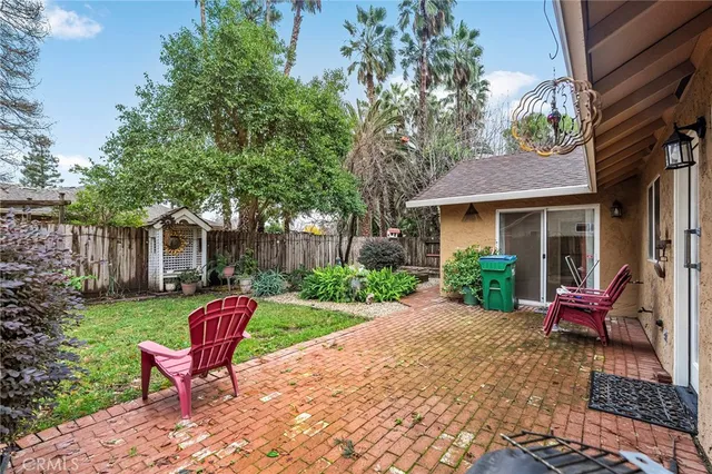 a view of a house with sitting area and garden
